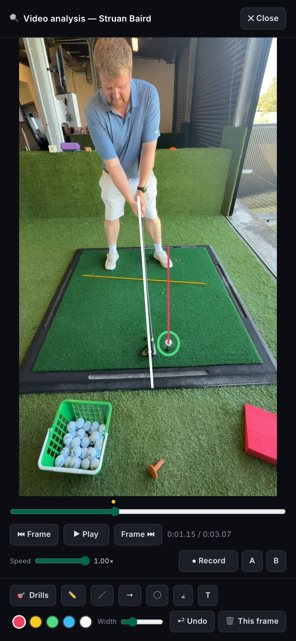 The CoachOS analyzer on a phone: a real swing with the coach's shaft line, ball circle and ball-position line drawn on it.